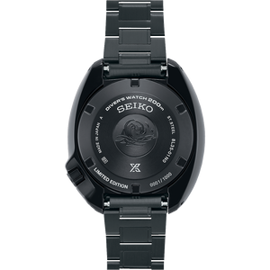 Black Seiko watch with detailed case back on a white background