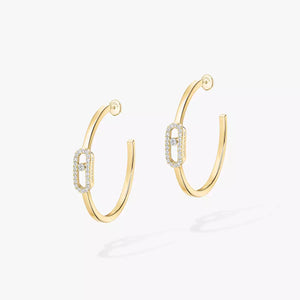 Gold hoop earrings with diamond accents on a white background