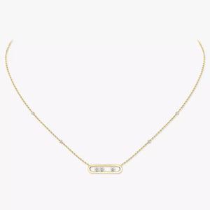 Gold necklace with a small pendant on a white background