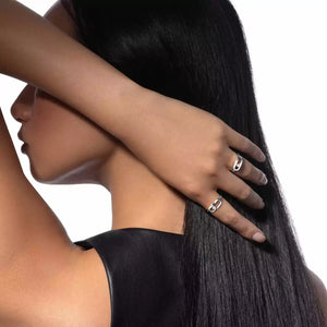 Woman with long black hair and silver rings on a white background