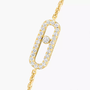 Gold bracelet with diamond accents on a white background