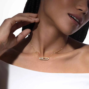 Close-up of a woman wearing a gold necklace with a white background