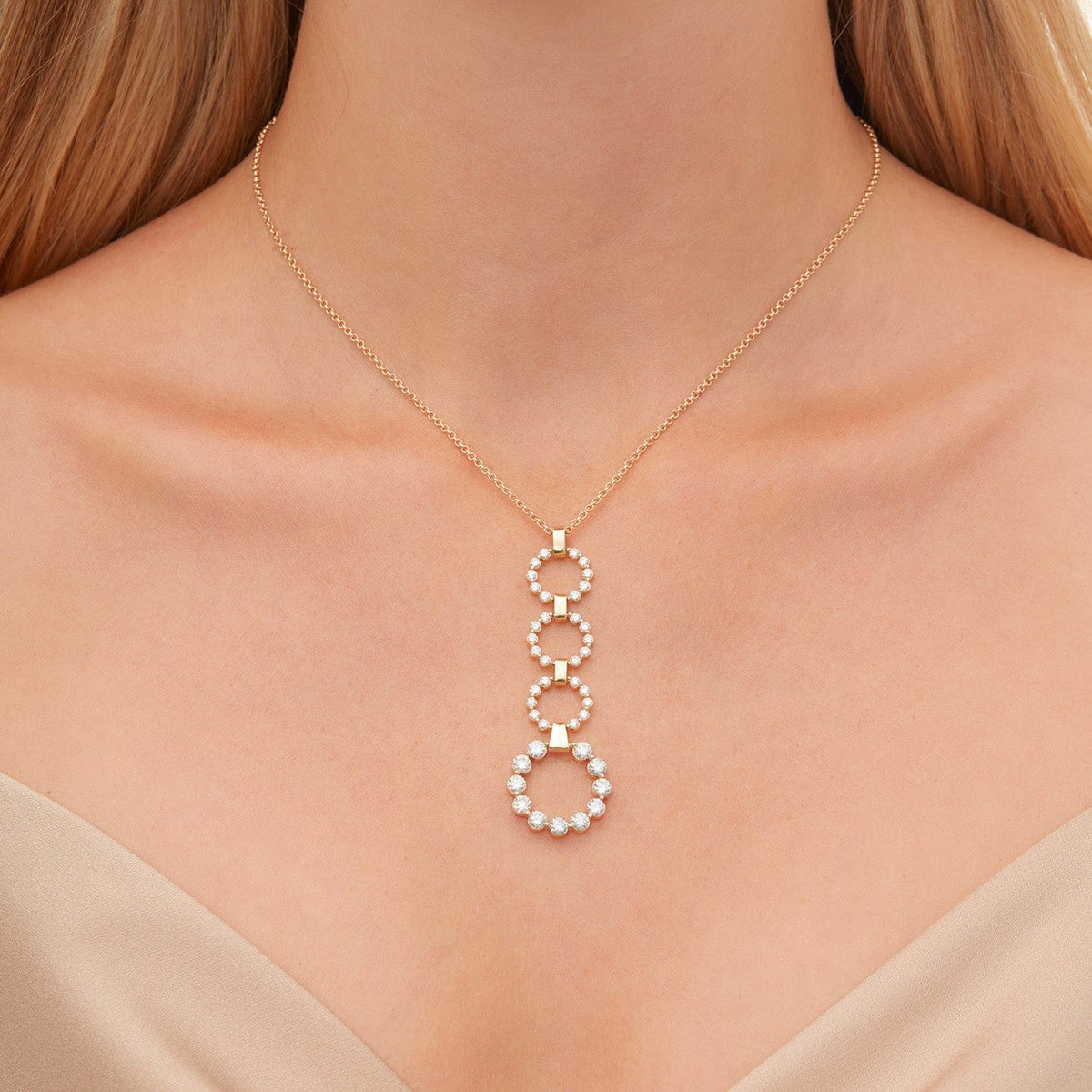 Front view of 2.80ctw Diamond Cloud Drop Pendant showcasing four articulated diamond rings with smooth gold bars on a model