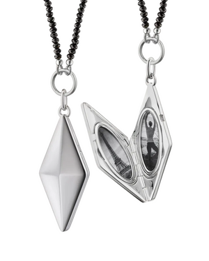 a silver diamond shaped locket that holds two images and has a black chain on a white background