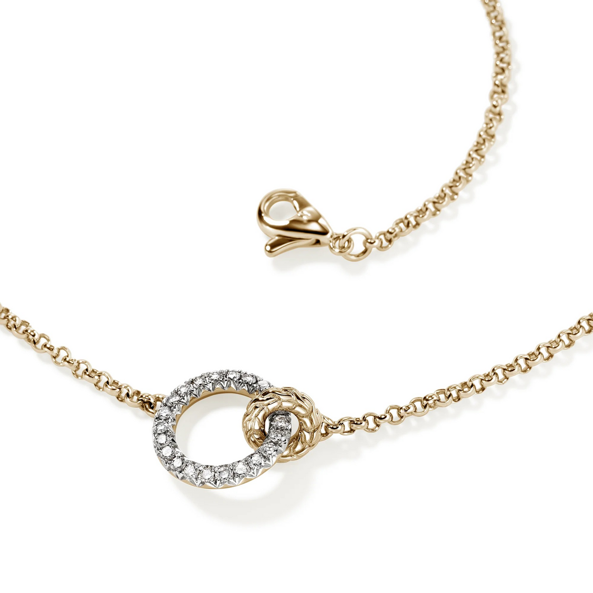 Close-up of 14K yellow gold and sterling silver necklace showing lobster clasp, mini Rolo chain and diamond pavé linked circles on white background