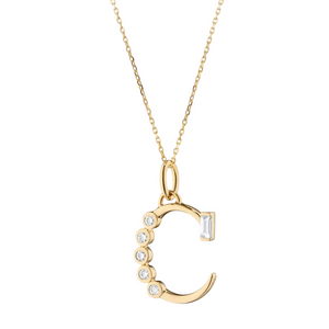 Gold initial C necklace with diamonds on a white background
