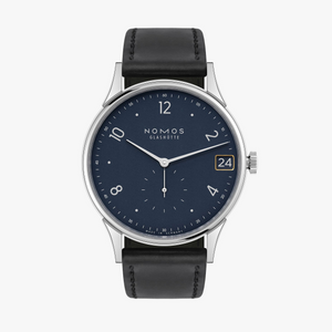 NOMOS timepiece with blue dial and black leather band on a white back ground