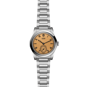 Front view of TUDOR Monarch 39mm showcasing champagne dial, small seconds subdial and stainless steel bracelet on white