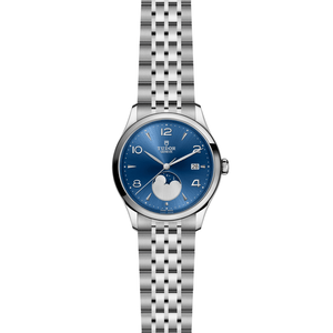 Front of TUDOR 1926 Luna watch showing blue sunburst dial with moon phase and stainless steel bracelet on white background