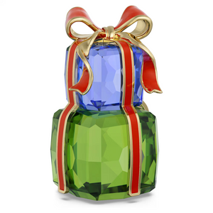 Stacked blue and green faceted crystal gifts wrapped with a red-and-gold ribbon and bow