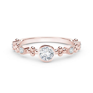Rose-gold ring with bezel-set round center diamond and milgrain bead accents