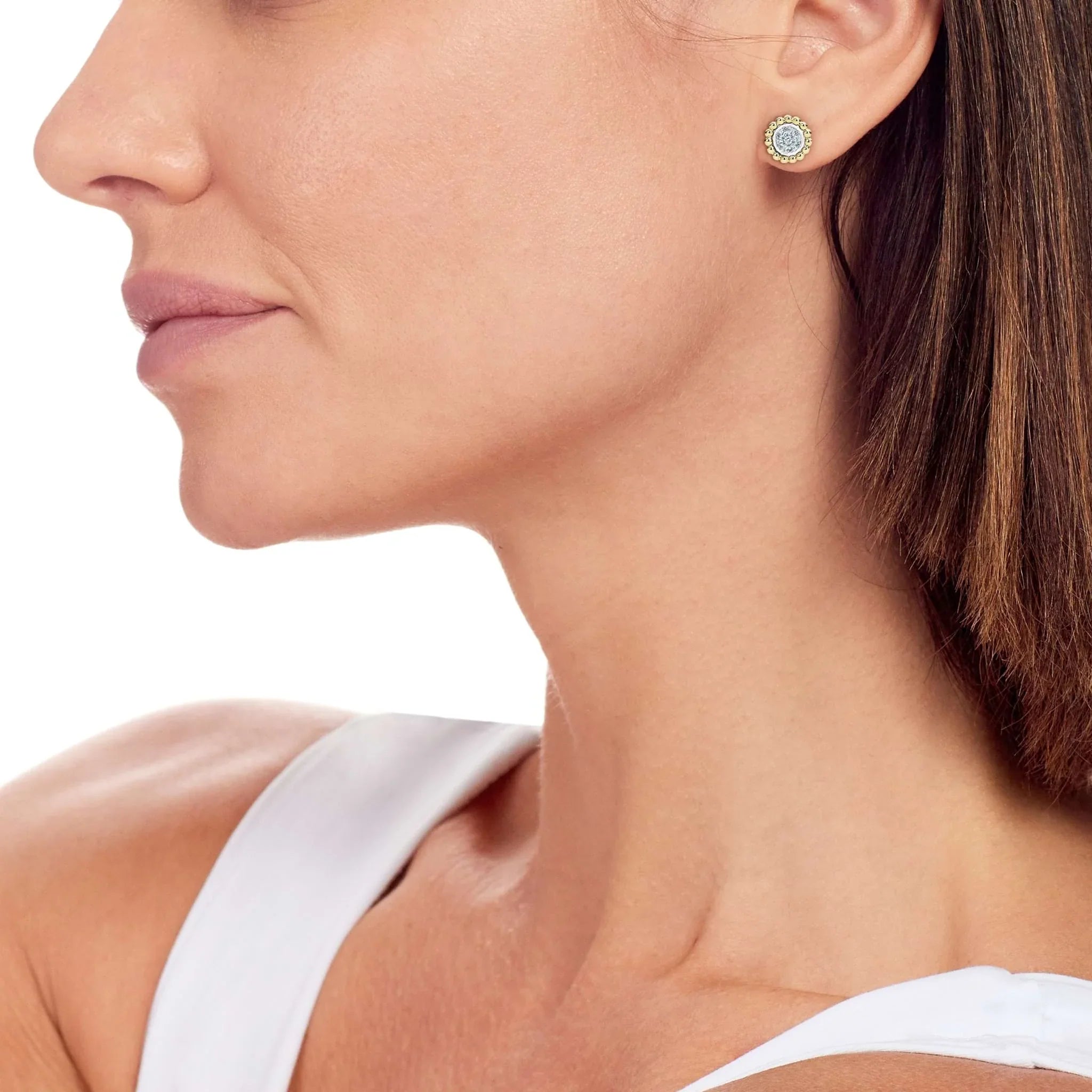 Side profile of model wearing two-tone caviar stud earrings with 0.14ctw pave diamond center and 18K gold Caviar beading