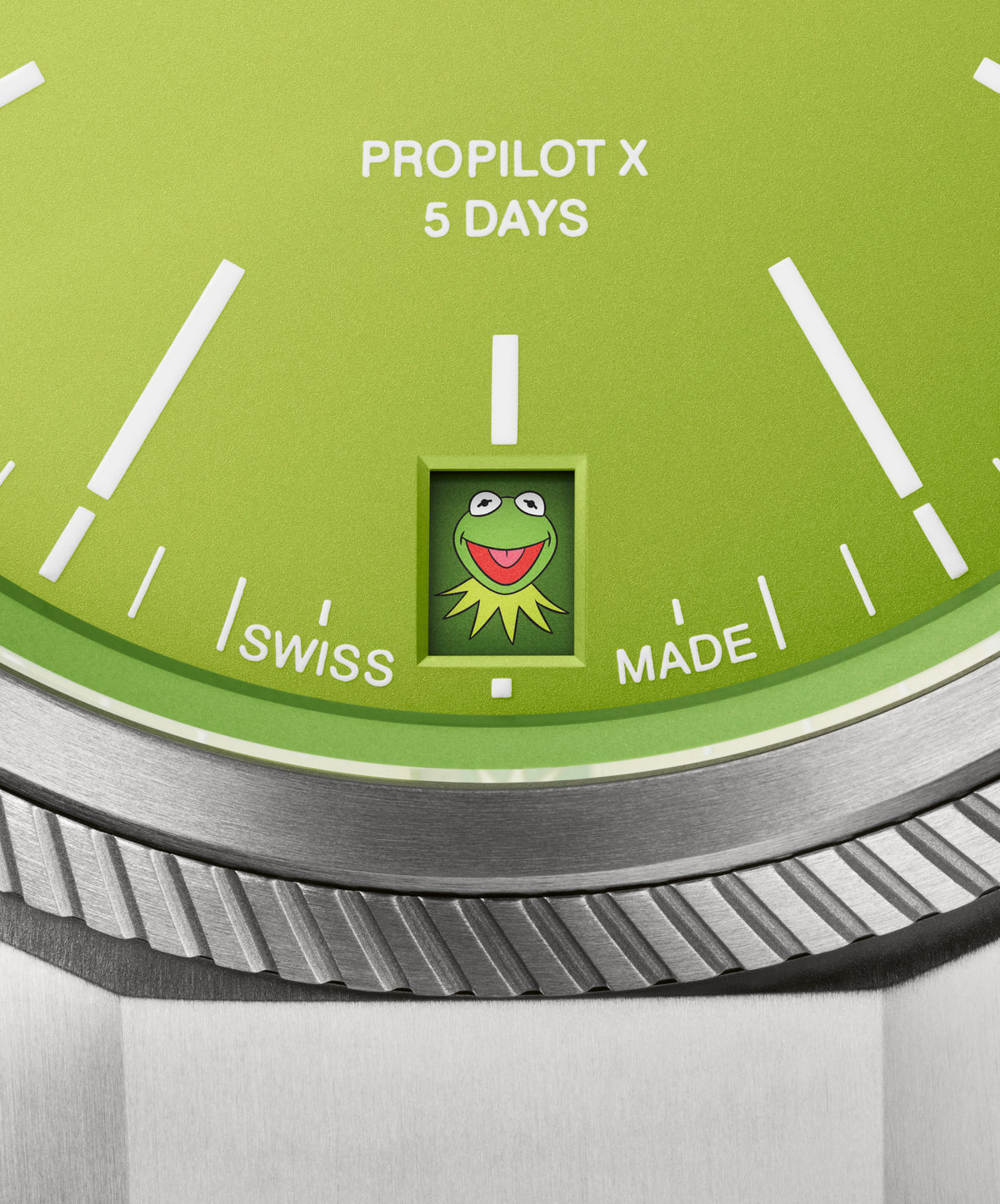 Close-up of Oris ProPilot X Kermit dial showing green, PROPILOT X 5 DAYS text and Kermit date window with titanium bezel