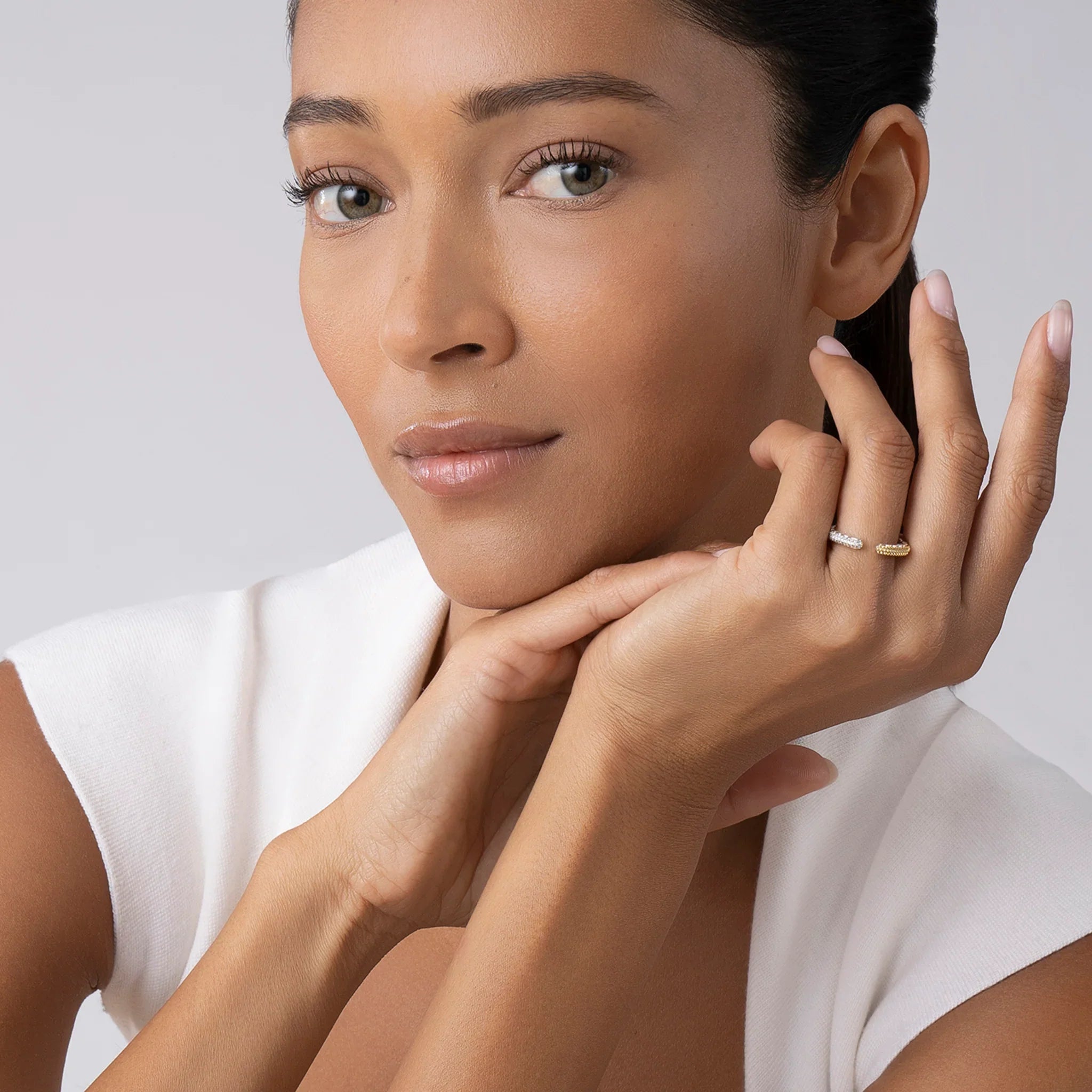 Close-up of hand wearing Open Diamond Stacking Ring: two open caviar-beaded bands in 18K gold and sterling silver