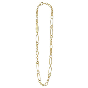 Flat lay of 18k gold link necklace showing alternating elongated oval links and textured caviar-beaded links on white background