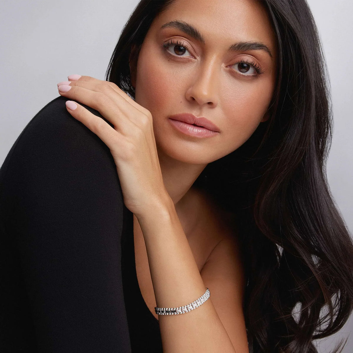 Close up of model’s wrist wearing Small Single Station Diamond Circle Caviar Bracelet 7mm showing single diamond station and sterling silver caviar beading