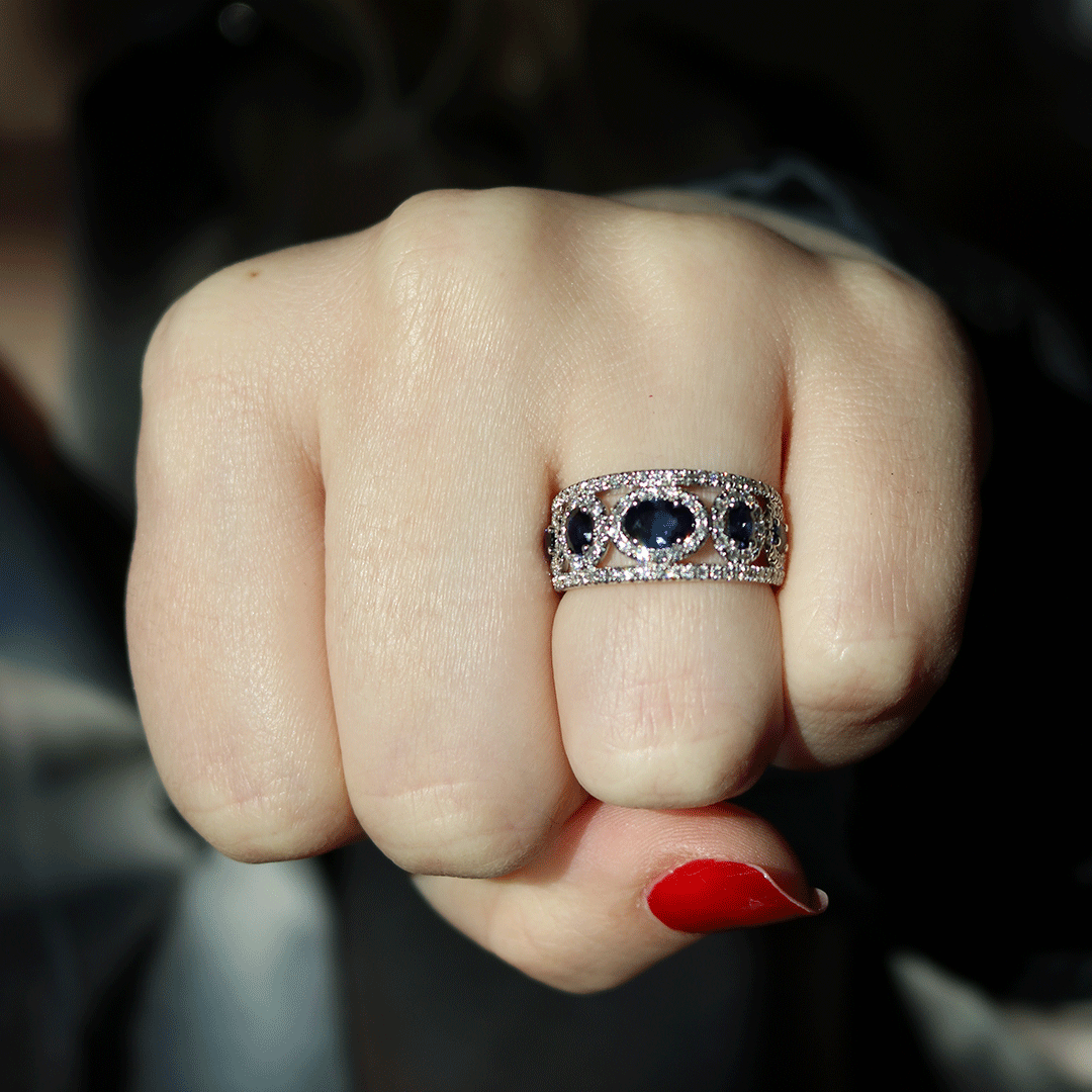 Close-up of Blue Sapphire, 0.65ctw Diamond Fashion Ring showcasing blue sapphires and diamond accents on a hand