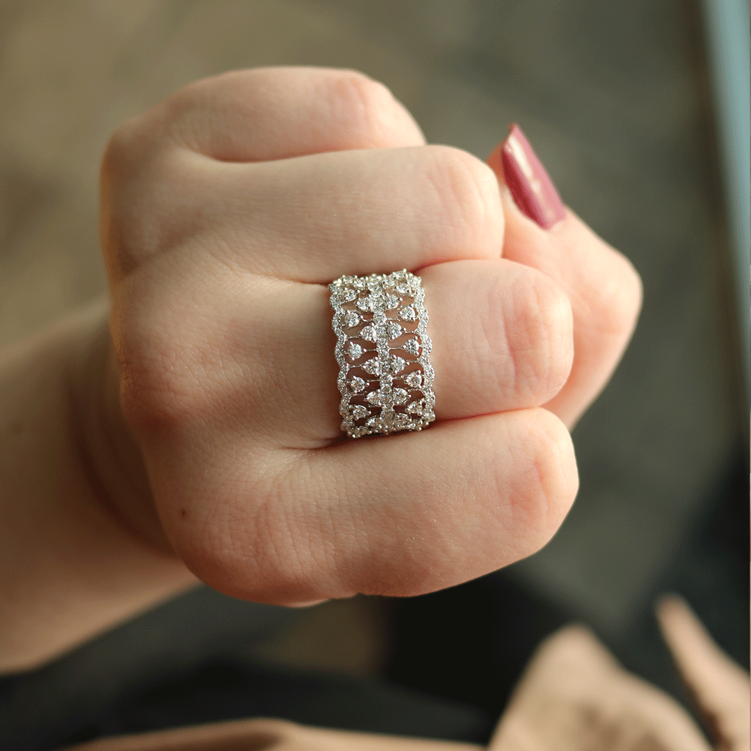 Close-up of 1.10 ct diamond fashion ring on a hand, showing open lace filigree band with three rows of round diamonds