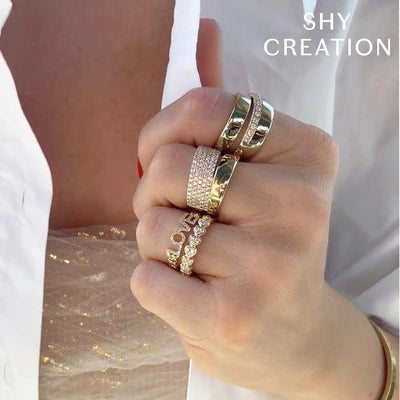 Close-up of hand wearing 1.03ctw pavé-set diamond ring on 14K yellow gold band with SHY CREATION overlay