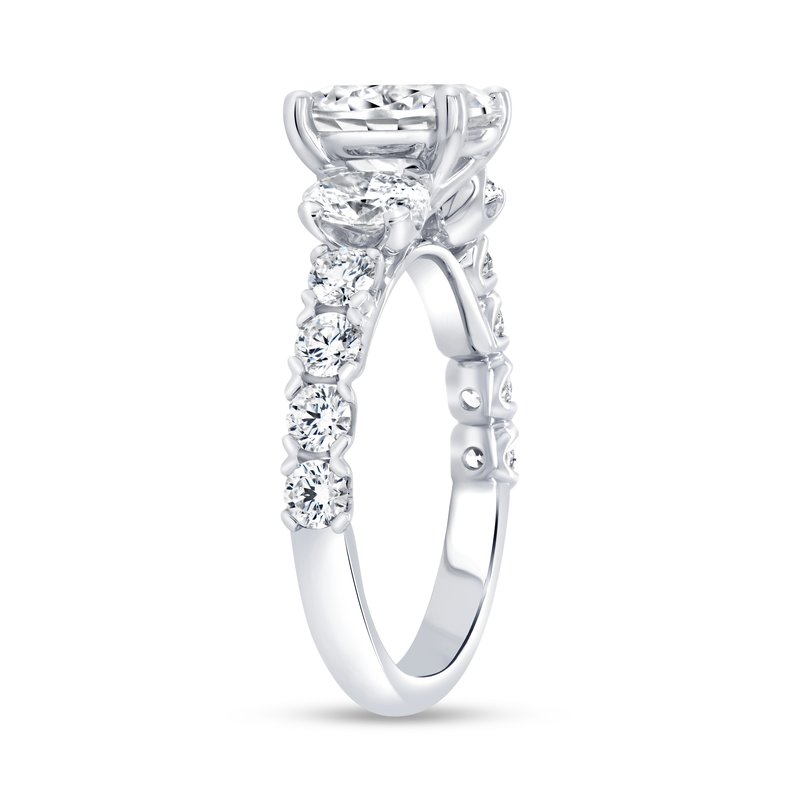 Side view of Uneek 1.33ctw engagement ring with 7x9mm oval center and round and oval accent diamonds on white background