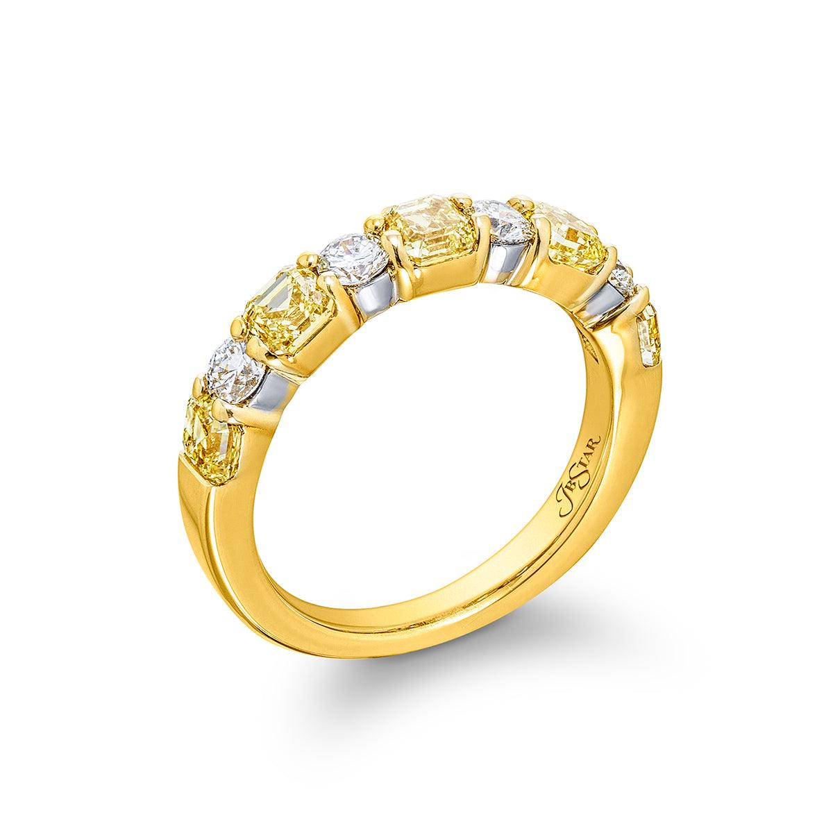 Angled view of Fancy Yellow emerald-cut and round diamond band in 18K yellow gold on white background
