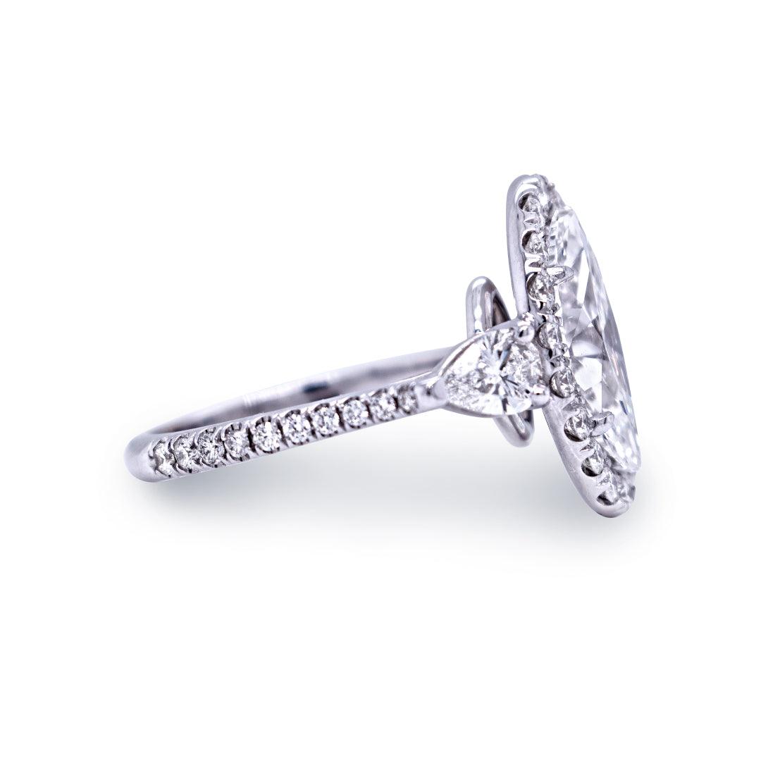 Side view of Oval Diamond Halo Engagement Ring in 14K white gold showing 2.85ctw oval center, pear side stones and pavé diamond band on white background