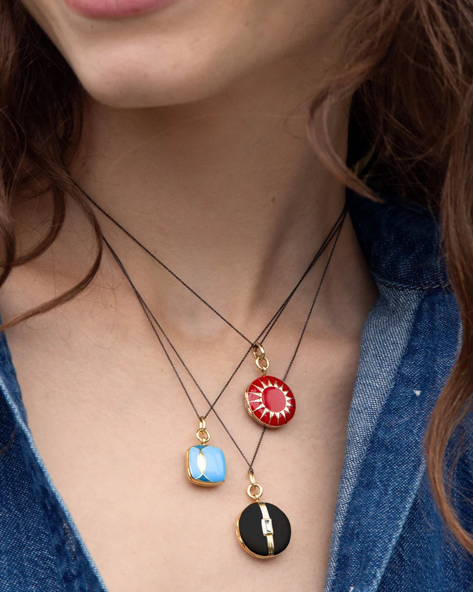 close up of a woman wearing multiple necklaces in different colors