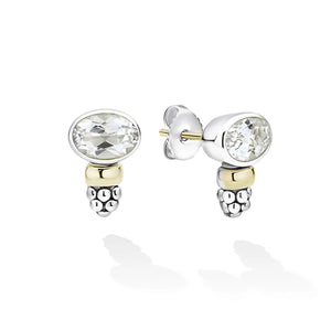 A pair of silver and yellow gold stud earrings with oval-cut white gemstones, shown on a clean white background with soft reflections.