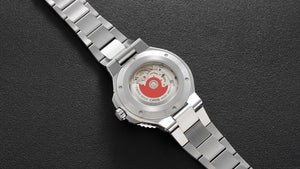 Silver watch with a detailed face on a dark background