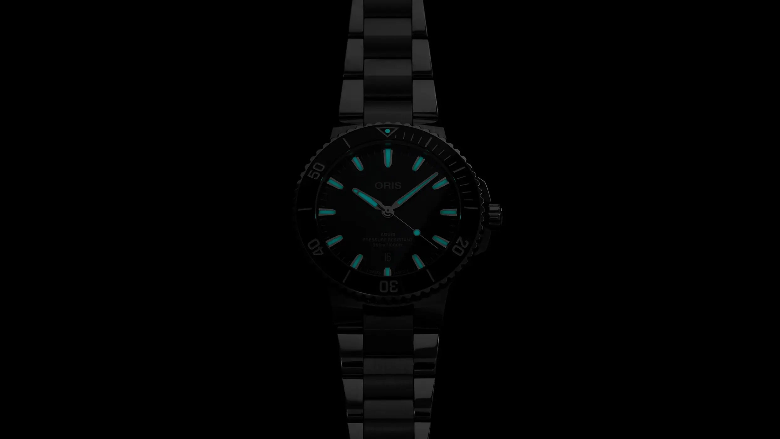 Black wristwatch with blue glowing hands on a black background