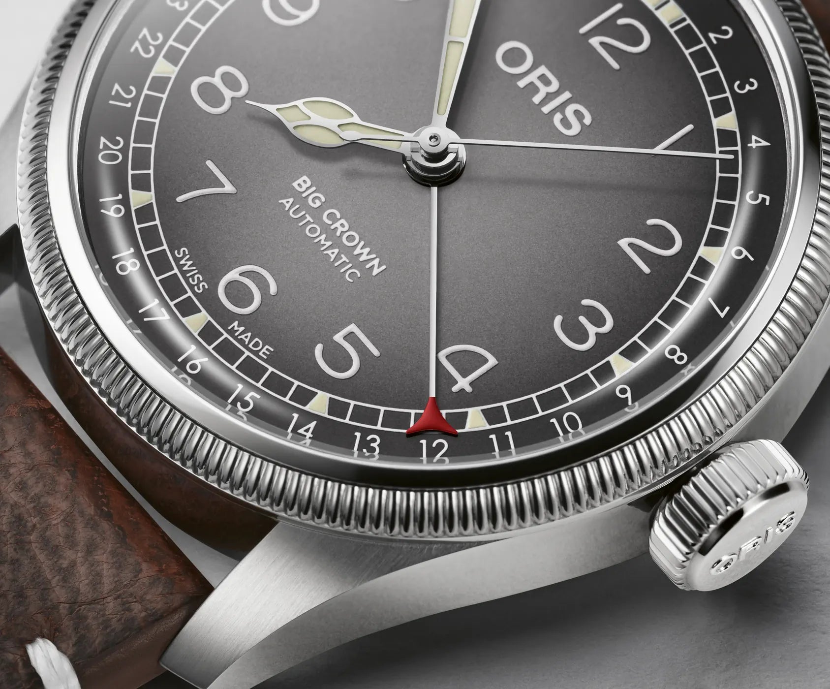 Oris watch with detailed dial and brand name on a wrist.
