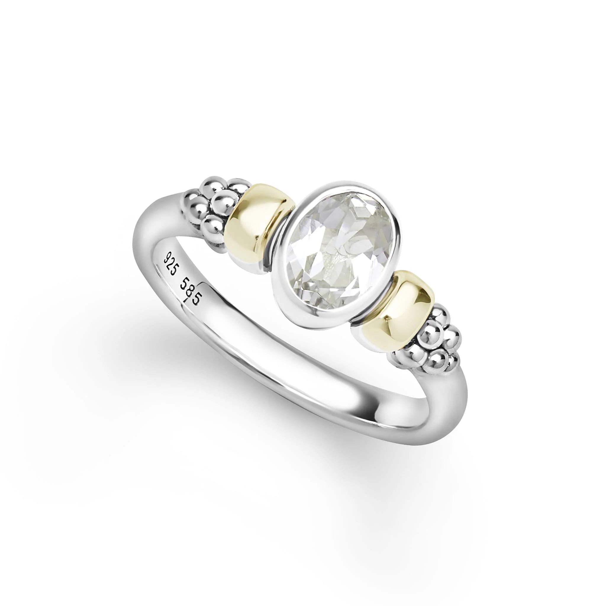 two tone ring with a white topaz oval center stone on a white background