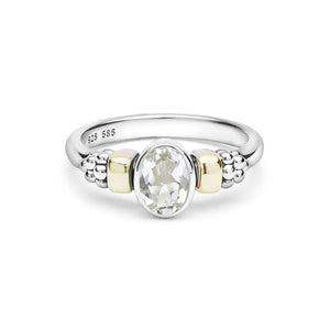 two tone ring with a white topaz oval center stone on a white background