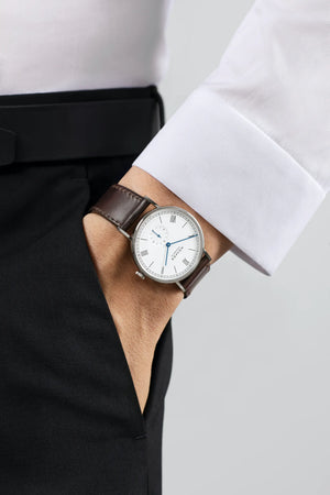 Close-up of a wrist wearing a watch with a white background