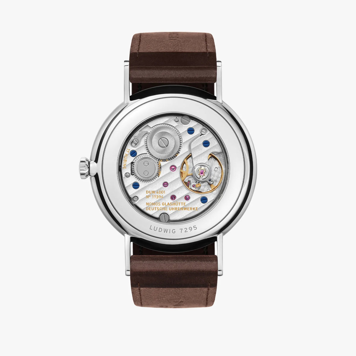 Back of NOMOS timepiece see through back with moving parts on a brown leather band.