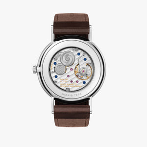 Back of NOMOS timepiece see through back with moving parts on a brown leather band.