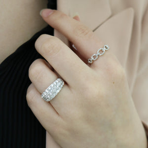 Close-up of hand wearing Diamond 3-Row Fashion Ring showing three rows of pavé diamonds in 18K white gold against black top and beige jacket