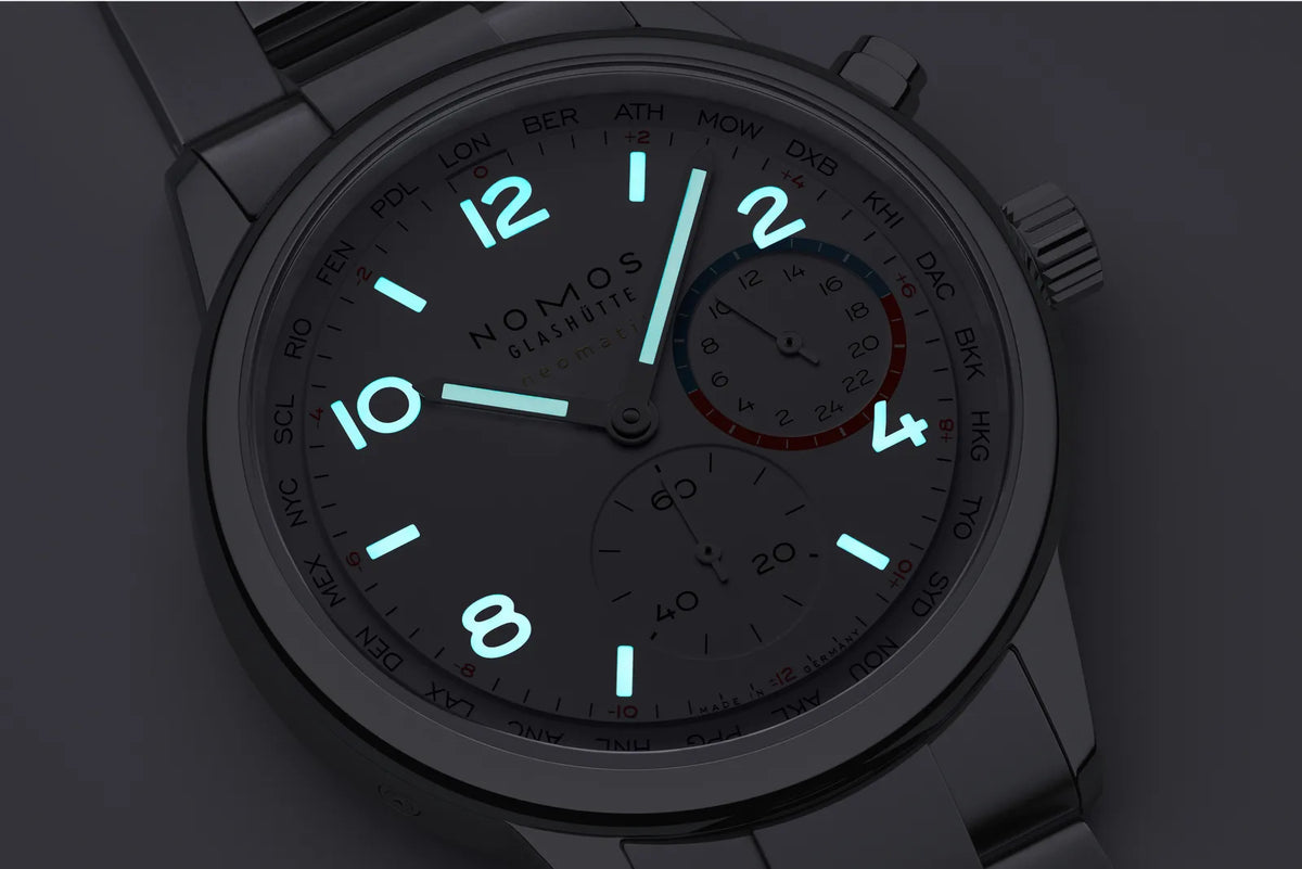 Glowing watch face on a dark background