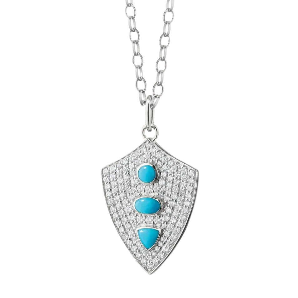 sterling silver shield necklace with white sapphires and turquoise stones on a white background