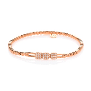 Flat-lay of Tresore stretch bracelet in 18K yellow gold with three pave diamond clusters on a beaded stretch band