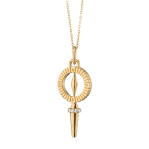 gold compass key necklace on a white background