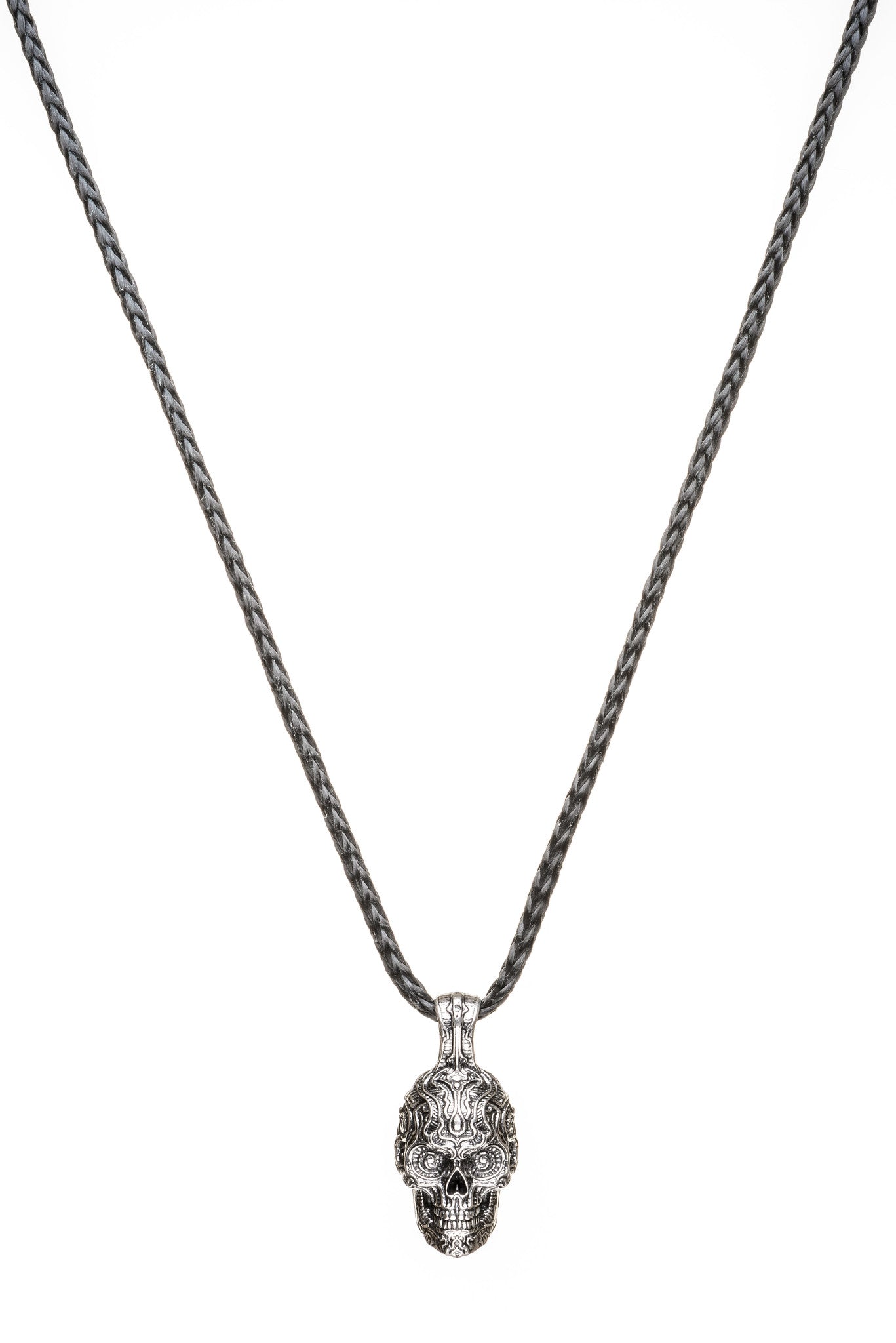 Front view of William Henry Cristobal skull pendant in sterling silver with engraved sugar-skull details on braided chain