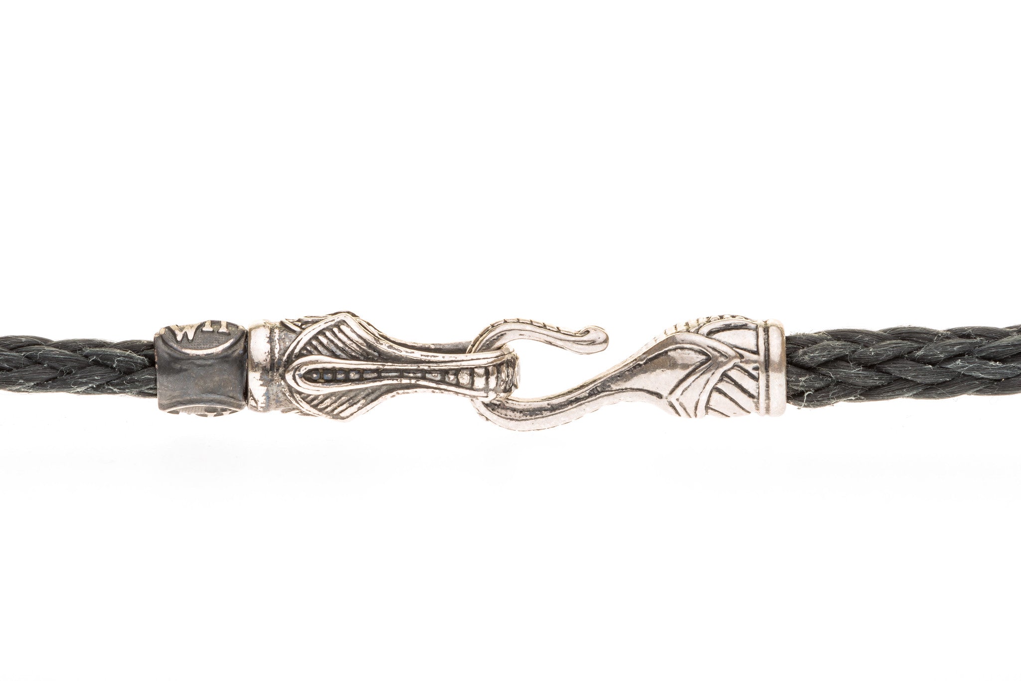 Close-up of braided black leather necklace showing engraved sterling silver hook clasp on white background