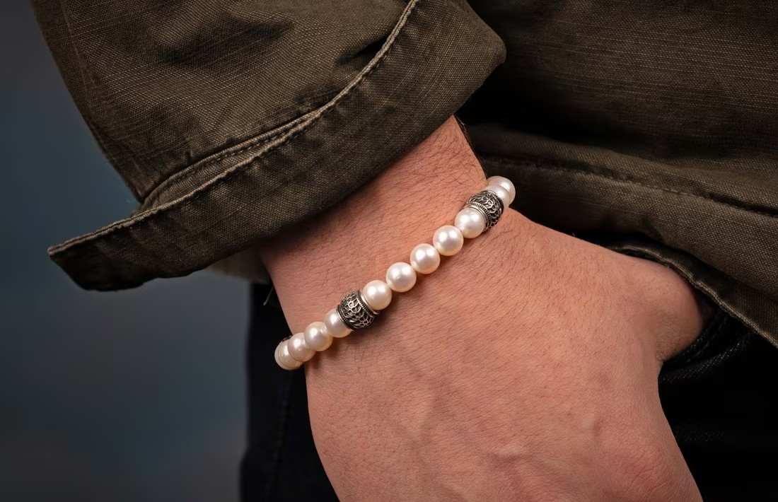 Pearl bracelet with decorative silver beads on a wrist, William Henry 'Full Moon' design
