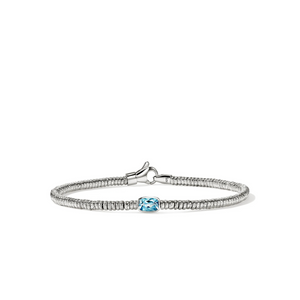 A silver-toned beaded bracelet featuring a central cushion-cut light blue gemstone, displayed on a clean white background.