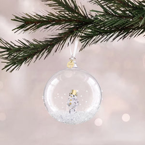 glass ball ornament with crystals and  with 2026 engraved on a gold tone plated tag with white ribbon hanging from a tree on a white shimmery background