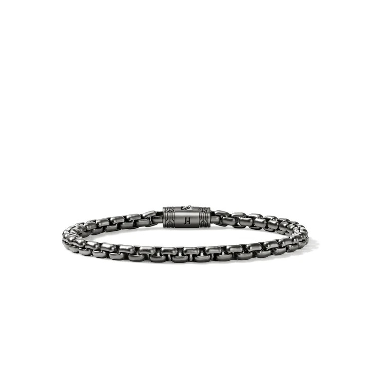 Gunmetal chain bracelet with tubular engraved clasp marked "H".
