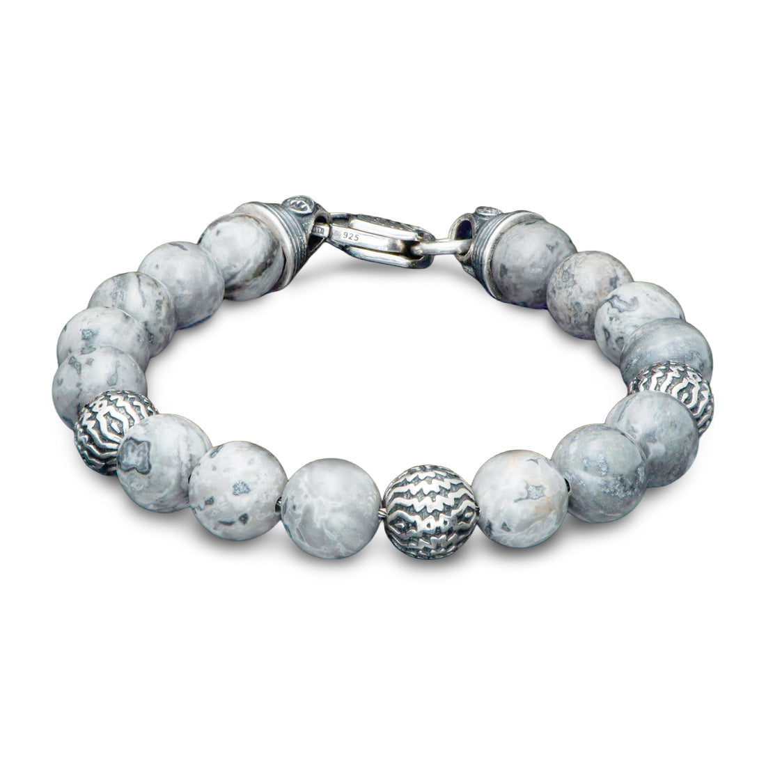 Angled overhead view of William Henry Seaside silver agate bracelet showcasing marbled gray agate beads, patterned sterling-silver spacer beads, and lobster clasp on white background