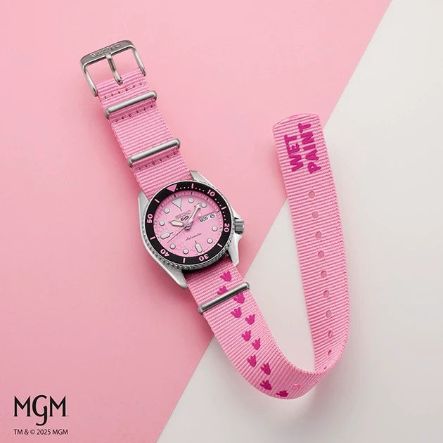 Pink watch with heart pattern strap on a pink and white background, featuring the MGM brand.