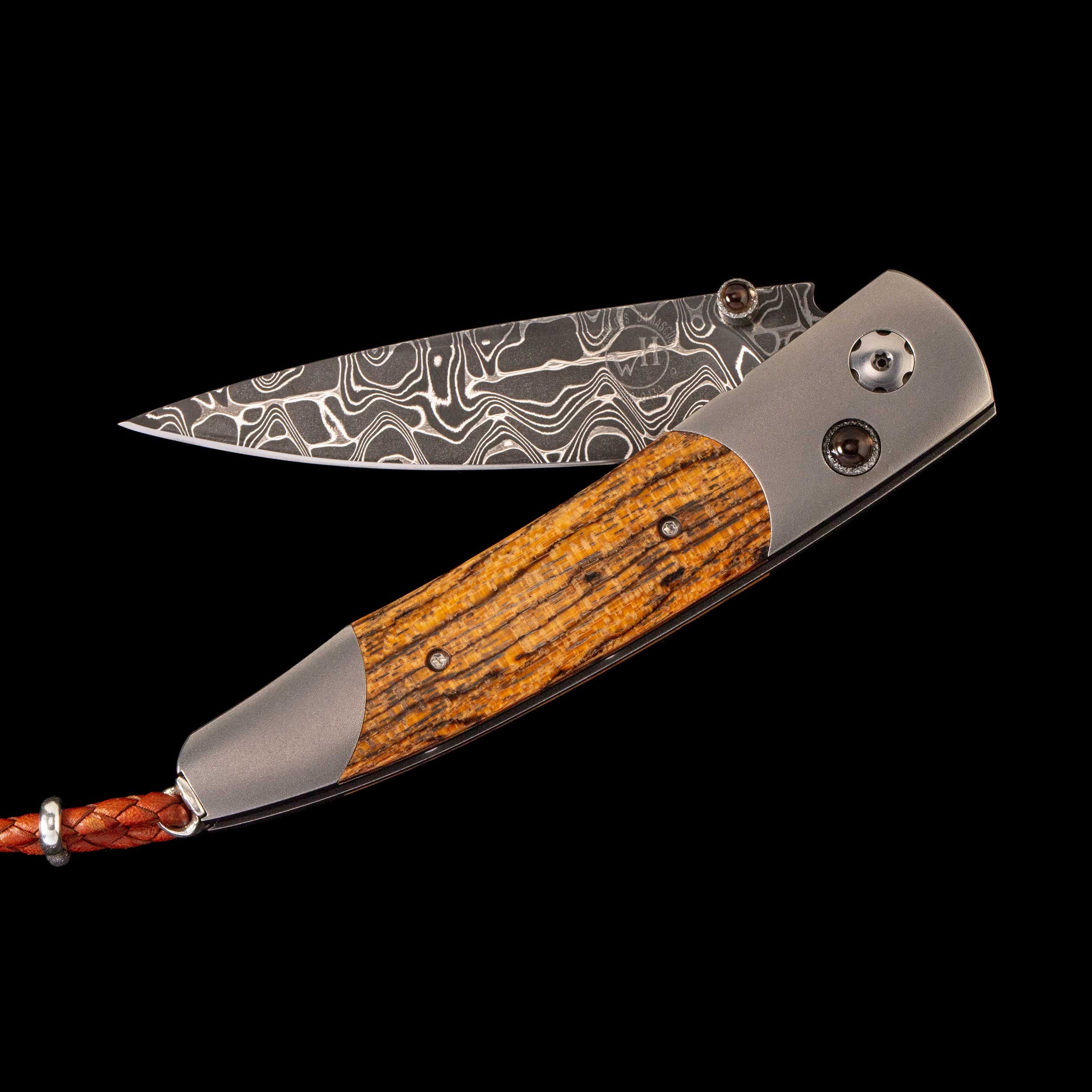 Folding pocket knife with Damascus-pattern blade, zebrawood handle and braided leather lanyard, "wh" logo on blade